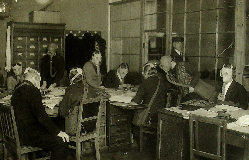 Сотрудники Бухгалтерии ВНИИМ в противогазах, за работой. 1938 год.